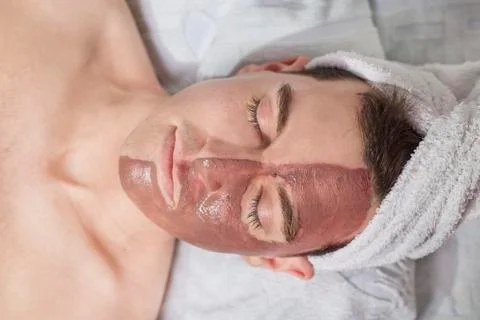 Man with a mud mask on this face Stock Photos