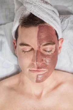 Man with a mud mask on this face Stock Photos