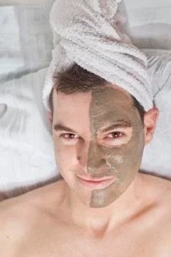 Man with a mud mask on this face Stock Photos