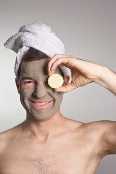 Man with a mud mask on this face Stock Photos