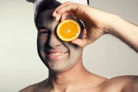 Man with a mud mask on this face Stock Photos
