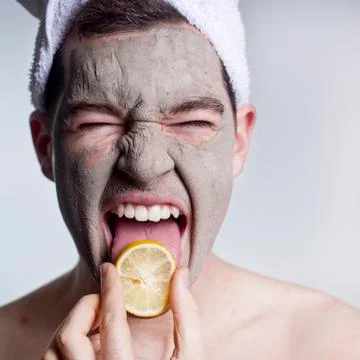Man with a mud mask on this face Stock Photos