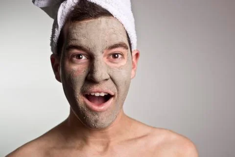 Man with a mud mask on this face Stock Photos