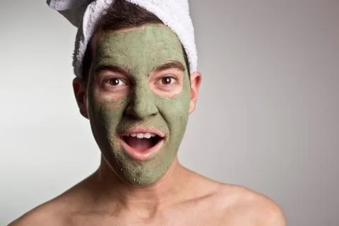 Man with a mud mask on this face Stock Photos