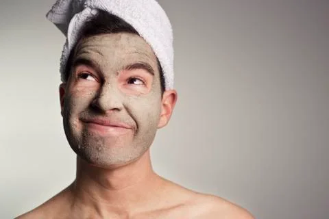 Man with a mud mask on this face Stock Photos