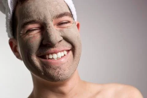Man with a mud mask on this face Stock Photos