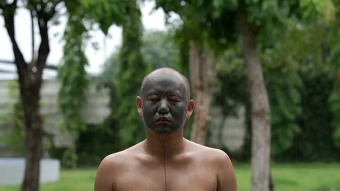 Man with mud mask on his face outdoor. Stockbeeldmateriaal 124822162