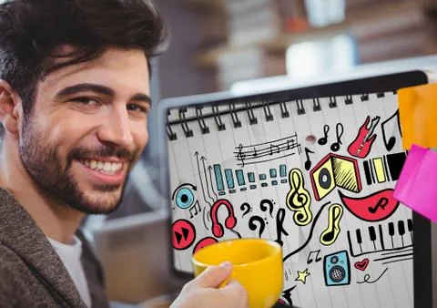 Man with mug sitting at computer showing music doodles on sketchbook Stock Photos