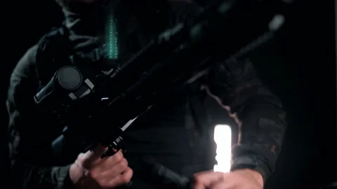 Man in the multicam attaches the store to the AK Video stock 144069502