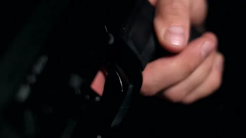 Man in a multicam on a black background pulls the trigger of a carbine Video stock 154002103