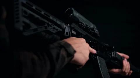 Man in a multicam throws his modernized machine gun into a combat position Stock Footage 144070946