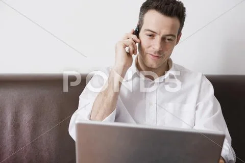 A man multitasking Stock Photos