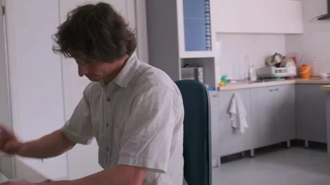 Man multitasks efficiently, handles gadgets during work, Person swiftly manages Stock Footage 326951973