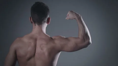 Man with muscular back posing in studio. Stockbeeldmateriaal 58144763