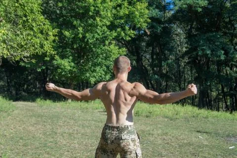 A man with a muscular back is practicing Stock Photos