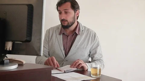 Man with a mustache and beard working on the computer at home Stock Footage 75559894