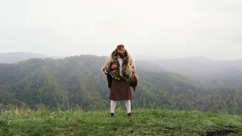 Man with mustache beard bear with a tattoo is standing mountain caucasian Stock Footage 110101279