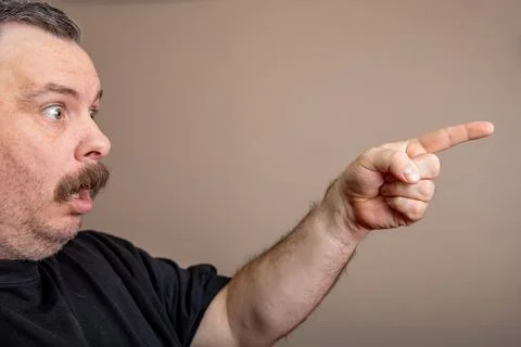 A man with a mustache pointing to something Stock Photos
