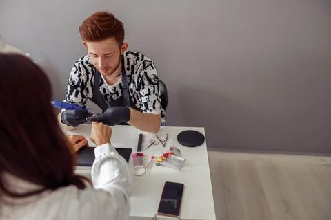 Man nail master working with client in beauty salon Stock Photos