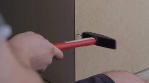 Man Nailing Wardrobe Back Panel With Hammer 스톡 동영상 338375098