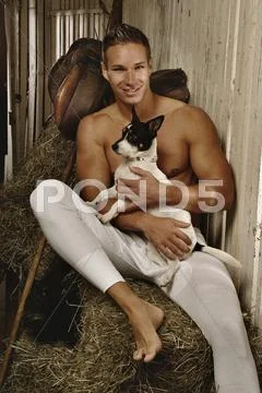 Photograph: Man with a naked torso wearing long underwear with a dog in