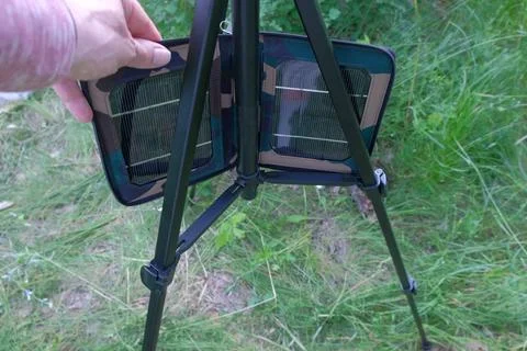Man in nature testing solar panel for hike visible object human hands grass Stock Photos