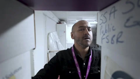 Man navigating through a cluttered office basement full of boxes and 動画素材 264906573