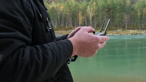 Man navigation flying quadcopter with remote control. Stock Footage 296090765