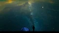 The man near a camping tent standing on the starry sky background. time lapse 4k or 4k+ Resolution