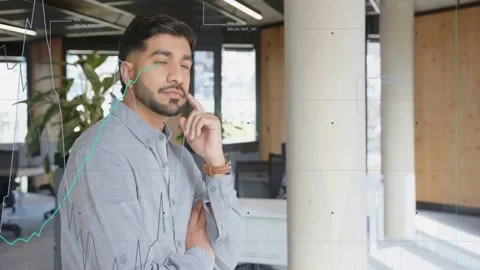 Man near column watching charts emerging left, tapping chin and evaluating Stock Footage 333078031
