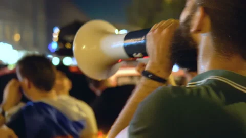 Man near crowd with shout agitates at rally angry man give strong speech Stock Footage