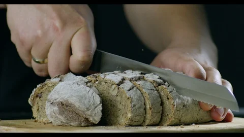 Man With A Neat Hands Cutting Bread On A Wooden Chopping Board Stock Footage 96197746