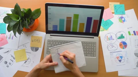 Man need rest concept, office laptop surrounded by a lot of paperwork, top view Stock Footage 87781690