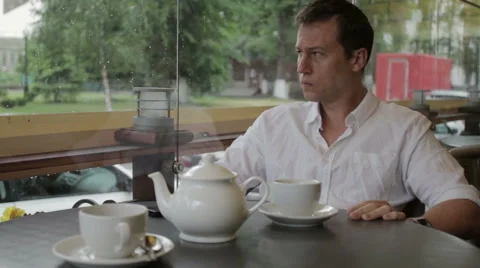 The man is nervous and looks at the clock waiting for the meeting sitting in a Stock Footage 68163674