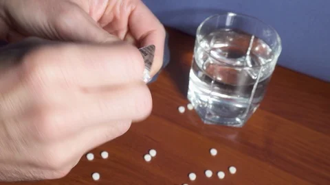 Man nervously extracting lots of pills Stock Footage 99732247