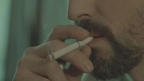 A man nervously lights a cigarette from a lighter, close-up. Stock Footage 299057384