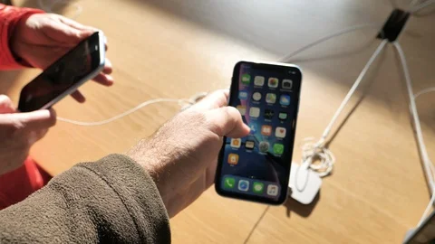 Man new Apple iPhone Xr red screen home lock Stock Footage 97538853
