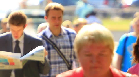 Man with  newspaper in crowd  .  Slow motion Stockbeeldmateriaal 25417243