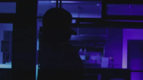 Man at Night with Blue Light in Background Stock Footage 194484132