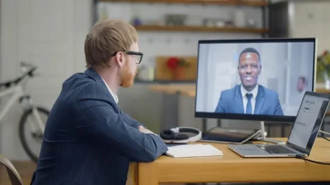 Man with no pants using laptop for online video conference from home Stock Footage 132171191
