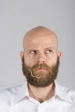 A man with a noodle in his beard Stock Photos