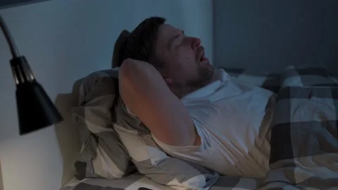 Man not able to fall asleep during night time. Male having sleep disorders. Guy Stockbeeldmateriaal 155004082