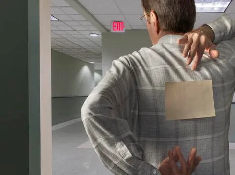 Man with note on back in hallway Stock Photos