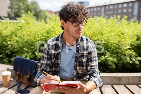 Man with notebook or diary writing on city street Stock Photos