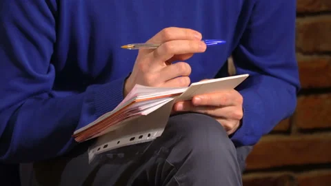 A man with a notepad listens to the speech at the conference Stock Footage 88339340