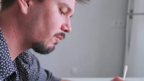 Man notes focus, male individual concentrating during notetaking, man Stock Footage 323856413