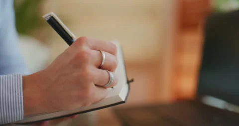 Man Notes Information in Notebook Stock Footage 276361976