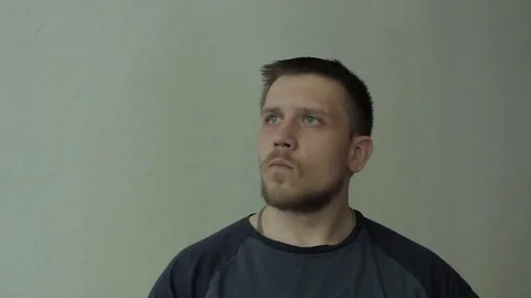 Man noticing the camera and trying to block it with the hand. Stock-Footage 77413395