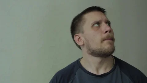 Man noticing camera and trying to see closer. Video stock 77413559