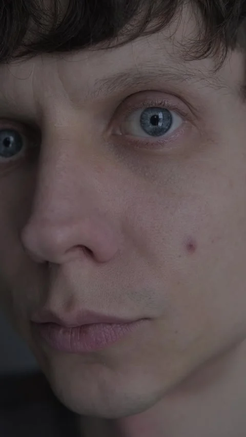 Man noticing single pimple on his face, examining skin in mirror, acne and Stock Footage 327743149